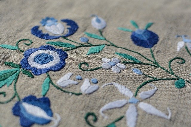 Látka s vyšívanými modrými kvetovými vzormi 
